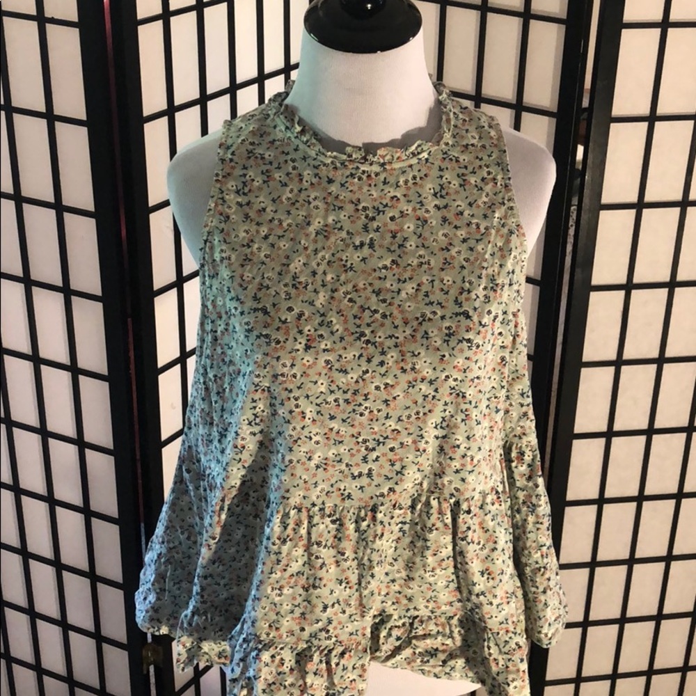 Floral patterned tank top with ruffled neck line.